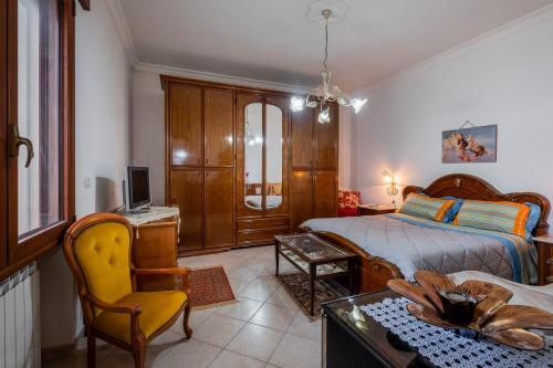 a bedroom with a bed and a desk and a chair at Villa Salento in Cellino San Marco