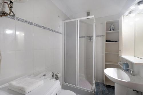 a bathroom with a shower and a toilet and a sink at Carpediem Playa La Arena in Puerto de Santiago