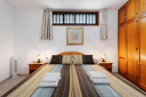 a bedroom with a large bed with two pillows at Carpediem Playa La Arena in Puerto de Santiago