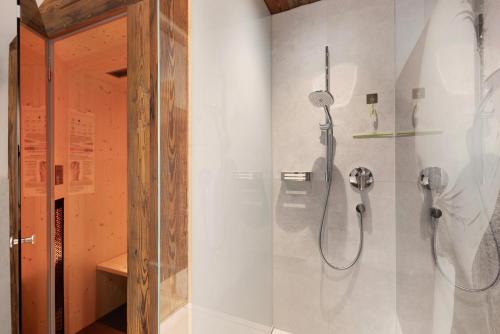 a shower in a bathroom with a glass door at Steineggerhof in Valle Di Casies