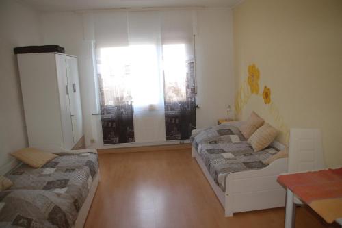 a living room with two beds and a window at Stylische Wohnung in Fellbach in Fellbach