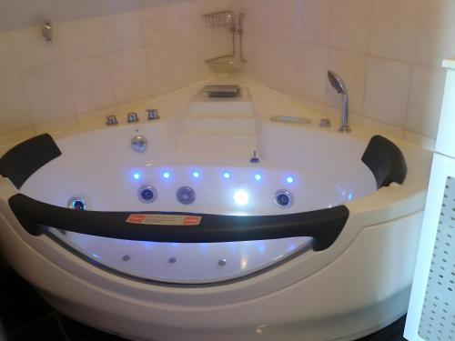 a jacuzzi tub with a faucet in a bathroom at Stylische Wohnung in Fellbach in Fellbach