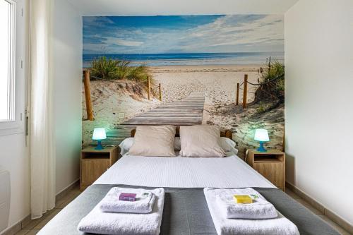 a bedroom with a bed with a painting of a beach at Villa Melchivany - Nature et Océan in Messanges