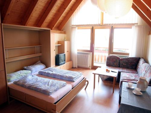 a living room with two beds and a couch at Sommerhof Rauber in Immenstaad am Bodensee