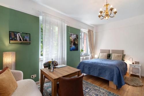 a bedroom with a bed and a table and a couch at Schlafen im historischen Haus in Weier