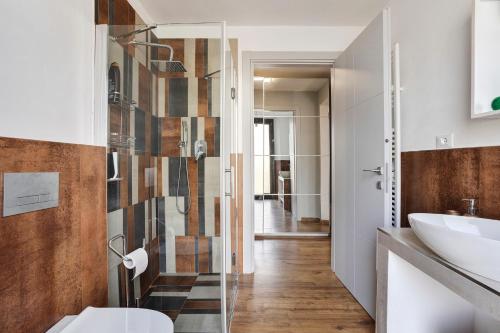 a bathroom with a glass shower and a sink at Cinque terre - Laspezia - Loft 1910 in La Spezia