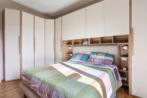 a bedroom with a large bed and white cabinets at Cinque terre - Laspezia - Loft 1910 in La Spezia