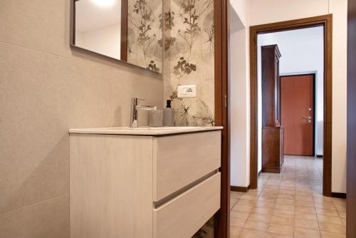 a bathroom with a sink and a mirror at Home Pier in Laveno-Mombello