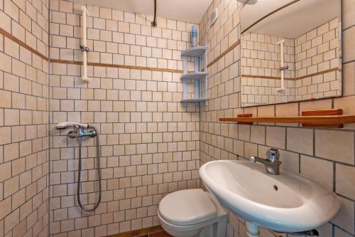 a bathroom with a sink and a toilet at Studio vue sur mer in Plomodiern