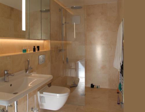 a bathroom with a toilet and a sink and a shower at Gartenstudio Peony in Innsbruck