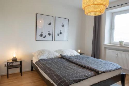 a bedroom with a bed and a window at Chiemsee Schwanenloft in Seebruck