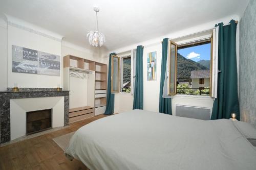 a bedroom with a bed and a fireplace at Chambre Verte in Auzat