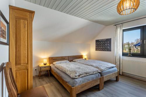 a bedroom with a bed and a window at Vista-Homert in Eslohe