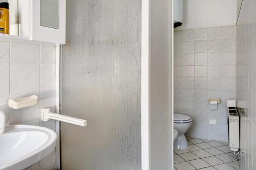 a small bathroom with a toilet and a sink at In Valtellina da Valter e Lella in Colorina