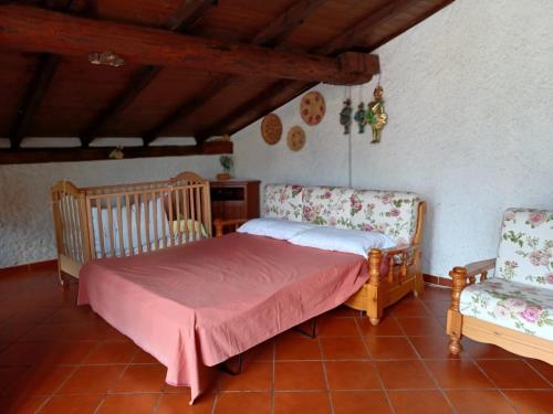 a bedroom with a bed and two chairs at In Valtellina da Valter e Lella in Colorina
