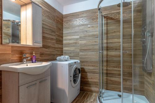 a bathroom with a washing machine and a sink at Archontiko Keli in Katákoilos
