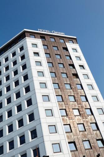a tall building with a sign on top of it at Hotel Cabinn Vejle in Vejle