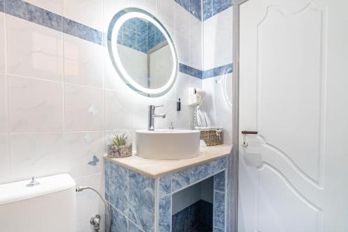 a bathroom with a sink and a mirror at Spyridoula Studio 4 in Paleokastritsa