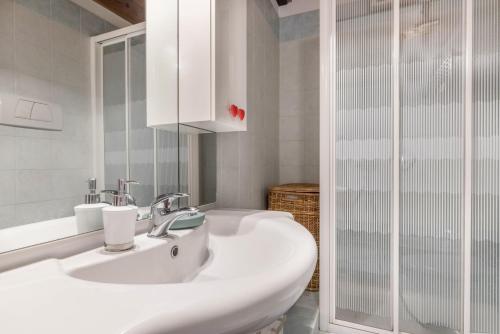 a white bathroom with a sink and a shower at Casa Giuly in Mirano