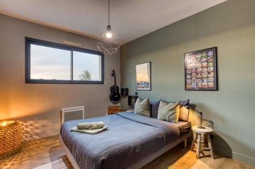 a bedroom with a bed and a window at Sublime Maison Moderne avec piscine in Mauguio