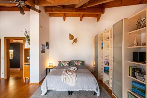 a bedroom with a bed with a blanket on it at Ferienwohnung Breitenberger in Herrsching am Ammersee