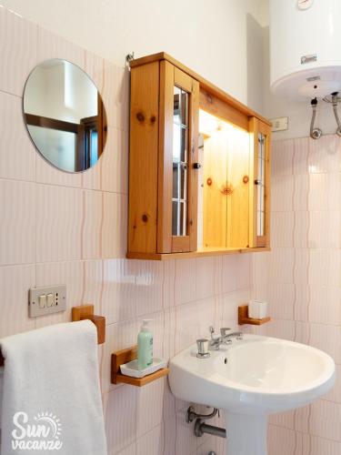 a bathroom with a sink and a mirror at Villa Malamuri in Budoni