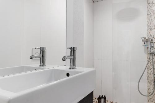 a bathroom with a sink and two faucets at Prestigegoldresidence 1 - Old Town in Guimarães