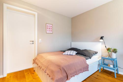 a bedroom with a bed with a blue end table at Fewo Kleines Glück in Friesenheim