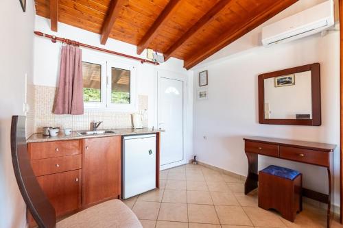 a kitchen with a sink and a counter at Alex bar apartments in Parga