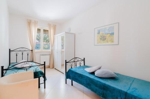a white room with two beds and a window at Casa vacanze Laura in centro in Otranto