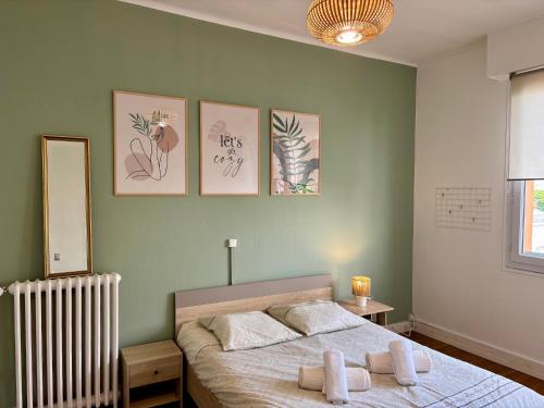 a bedroom with a bed with four pictures on the wall at Ty Foch in Lorient