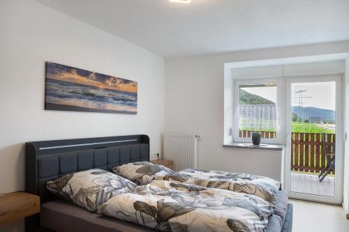 a bed in a room with a window at Ferienwohnung Krummel in Edertal