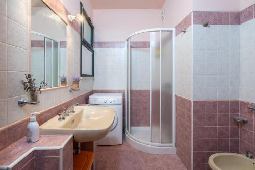 a bathroom with a sink and a shower at Ciumara East in Avola