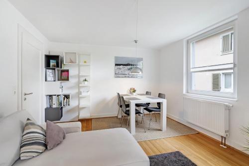 a living room with a white couch and a table at Haus No 6 in Lahr