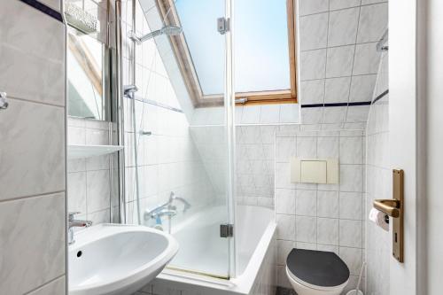 a bathroom with a sink and a toilet and a shower at Gita in Öhningen