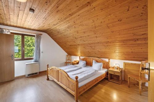 a bedroom with a bed in a wooden ceiling at Weingut Geiger in Meersburg