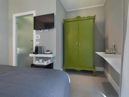 a green cabinet in a room with a bed at Anjoy&Bleev Rooms in Rho