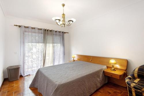 a bedroom with a bed and a window at Barra Sol - Lighthouse On The Beach in Gafanha da Nazaré