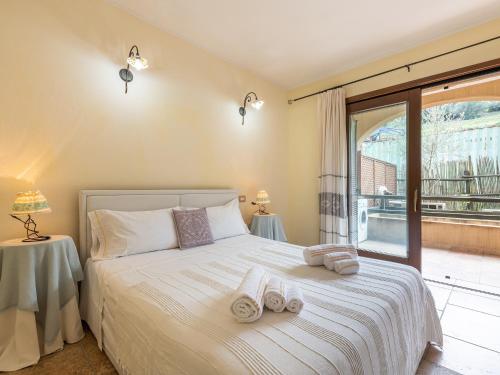 a bedroom with a bed with towels on it at Maison Pinella in Villasimius
