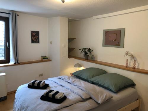 a bedroom with a bed with two pillows on it at das rote Ferienhaus Terlinden in Lieser
