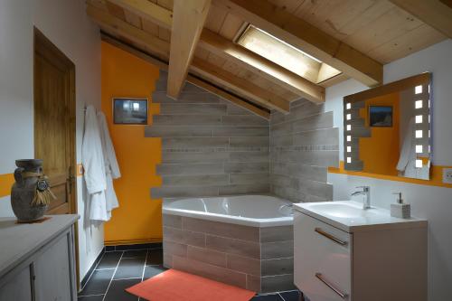 a bathroom with a tub and a sink at La Chambre De Jaxel in Saint-Martin-en-Vercors