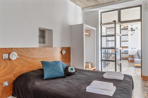 a bedroom with a large bed with two towels on it at A The Country House in Tinos