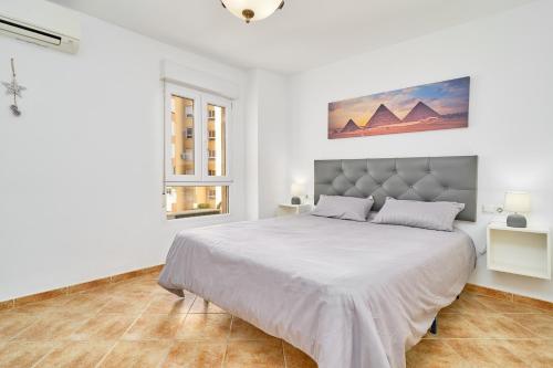 a white bedroom with a large bed in it at Apto Urb Centro Internacional A117 in Torrox