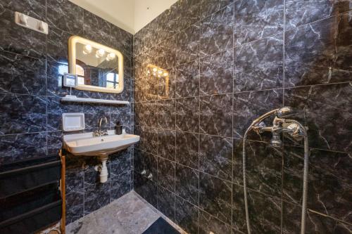 a bathroom with a sink and a shower at Nana's House Holidays Greece in Dragotiná