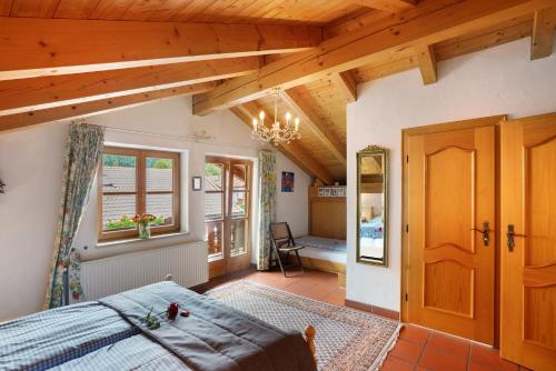 a bedroom with a bed and a wooden ceiling at Ferienhaus Werdenfels in Mittenwald