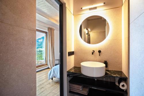 a bathroom with a sink and a mirror at Kraidlhof Designapartment Veronika in Cortaccia