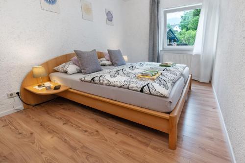 a large bed in a room with a window at Ferienwohnung Zapf in Forbach