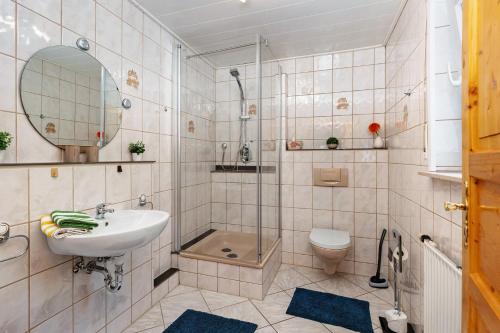 a bathroom with a sink and a shower and a toilet at Ferienwohnung Zapf in Forbach