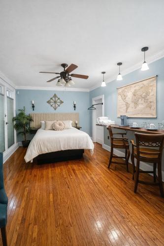 a bedroom with a bed and a desk and a ceiling fan at Town Square Charm Century Old in Lewisville
