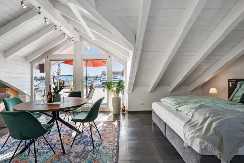 a bedroom with a bed and a table and chairs at Dachgeschosswohnung in Hofolding in Brunnthal